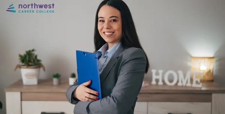 Smiling woman in a suit holds a clipboard, representing Business Administrative Assistants in a professional setting.