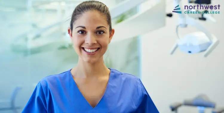 Smiling dental assistant in scrubs, representing How to Write a Standout Resume for a Dental Assistant Position.