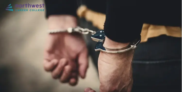 Hands in handcuffs symbolize the complex relationship between poverty and crime.