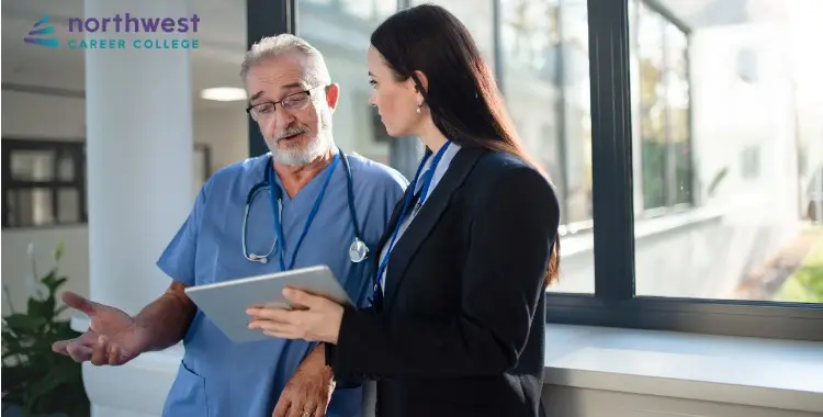 A healthcare professional discusses with a colleague, highlighting collaboration in the Healthcare System.