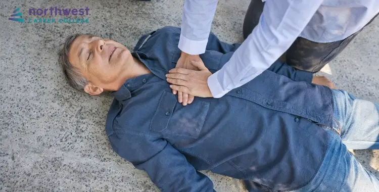 A person performs chest compression for senior citizens on an unconscious man lying on the ground.