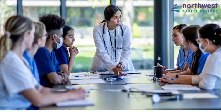 A healthcare leader instructs a diverse group of students in a classroom setting at Northwest Career College.