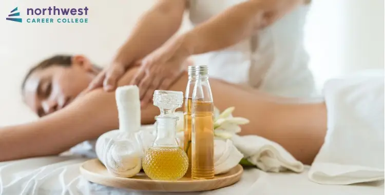 A massage therapist uses oils while a client relaxes, highlighting the benefits of incorporating aromatherapy into massage.