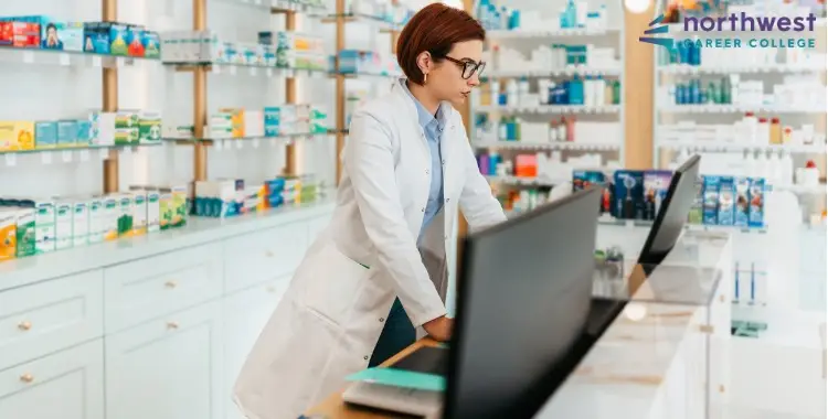 A pharmacy tech in a lab coat works at a counter, illustrating the difference between License vs. Certification of Pharmacy.