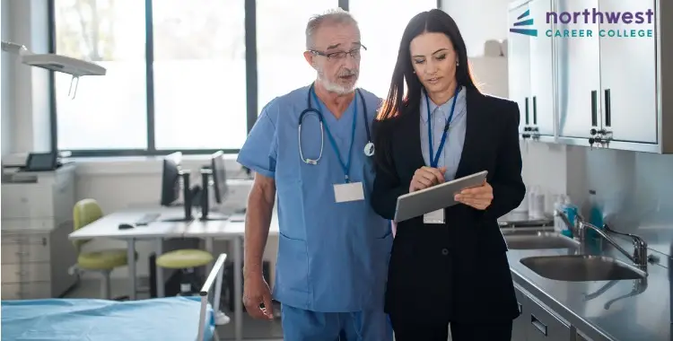 A healthcare administrator discusses daily challenges with a doctor, highlighting What Are the Challenges Healthcare.