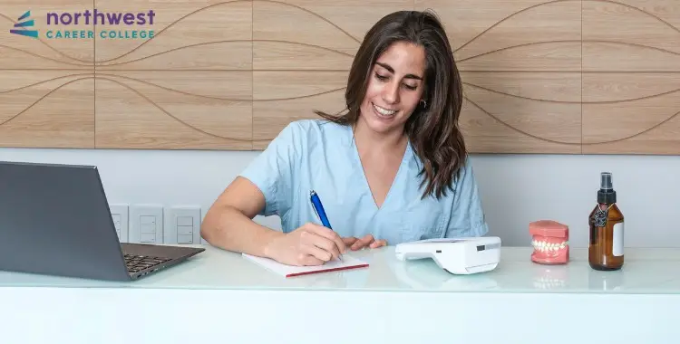 A healthcare professional writes notes on patient scheduling and appointment management at a desk with dental tools.