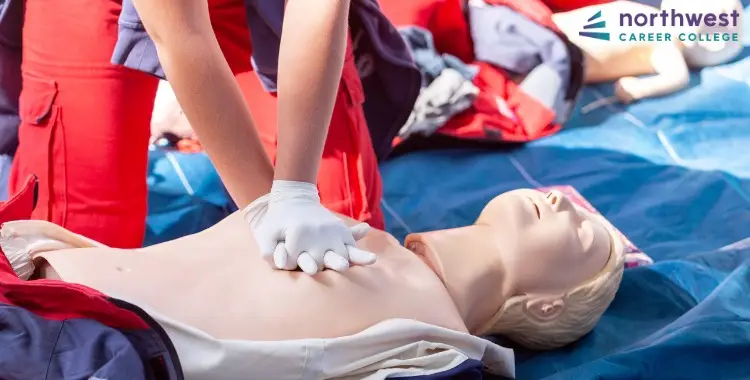 A person performs CPR on a training mannequin, demonstrating What is CPR in a hands-on learning environment.