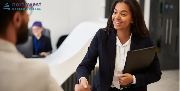 A corporate paralegal greets a colleague with a handshake, showcasing the Day-to-Day Life of a Corporate Paralegal.