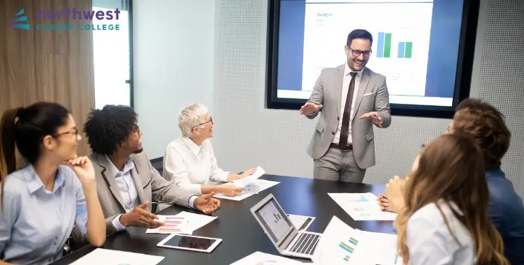 A diverse team discusses charts during a meeting, highlighting the influence of organizational culture on employee.