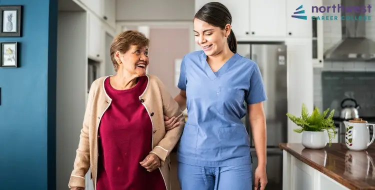 A smiling medical assistant helps an elderly woman walk in a bright, welcoming home. Become a Medical Assistant today!