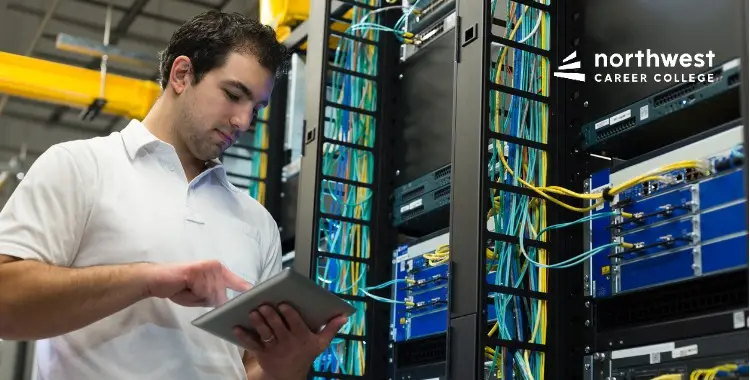 A technician uses a tablet in a server room, showcasing Remote Support Tools and Platforms for network management.