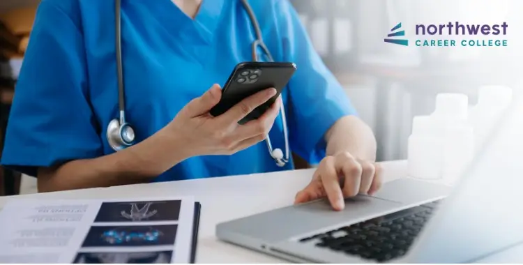 A medical assistant uses a smartphone and laptop, highlighting helpful mobile app tools for medical administrative.