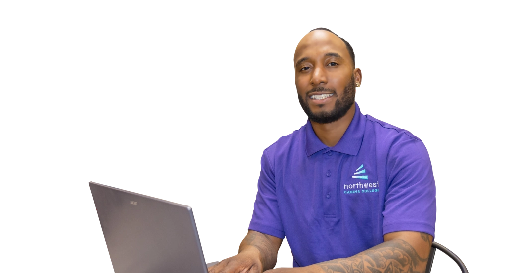 A man in a purple polo sits at a laptop, promoting a business administration degree at Northwest Career College.